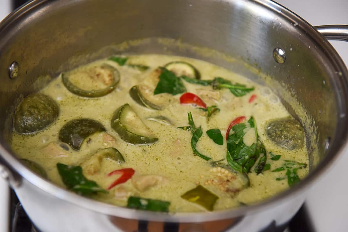 Add Makrut Lime Leaves, Basil, and Red Peppers to the Green Curry
