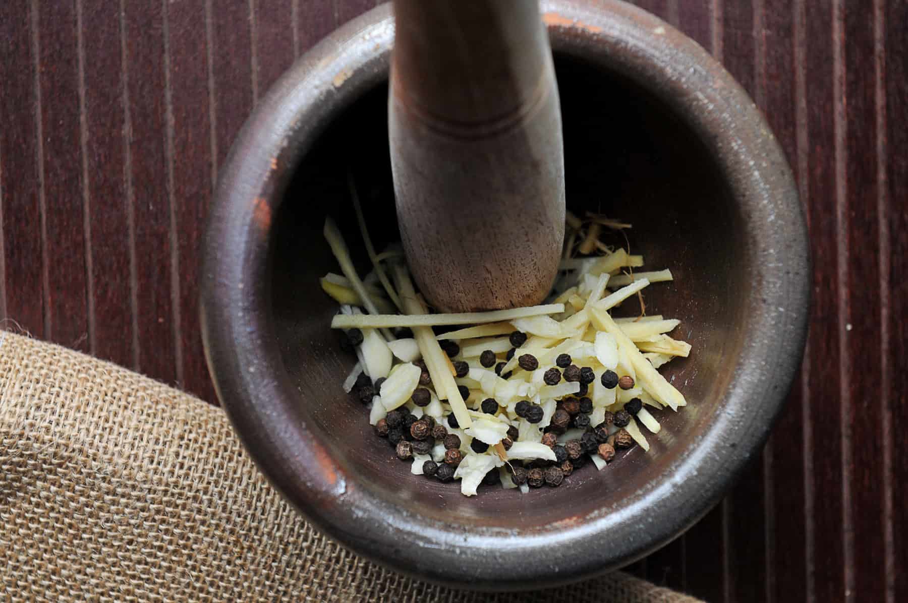 pound garlic, ginger, cilantro roots, and black peppercorns