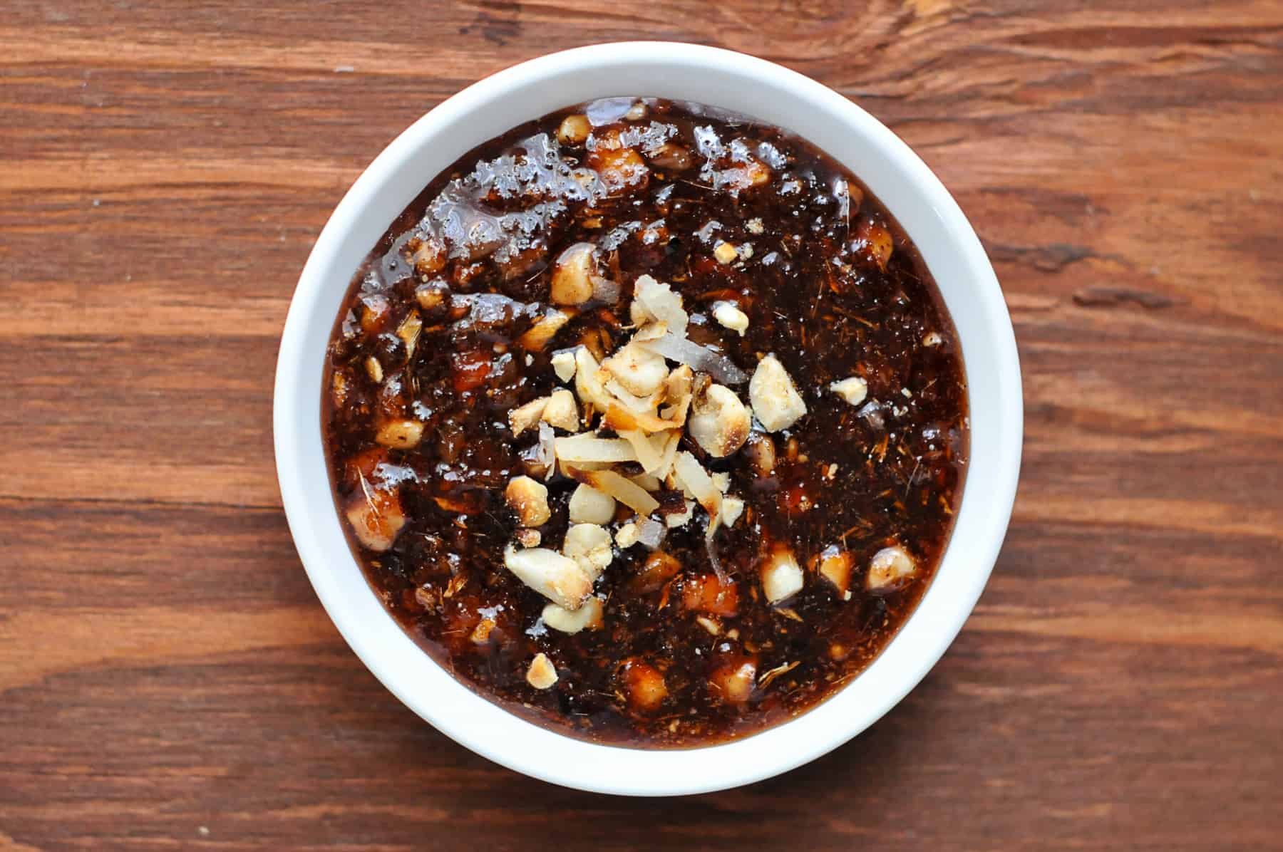 Cook the paste with palm sugar and fish sauce and top with toasted peanuts and toasted coconut flakes.