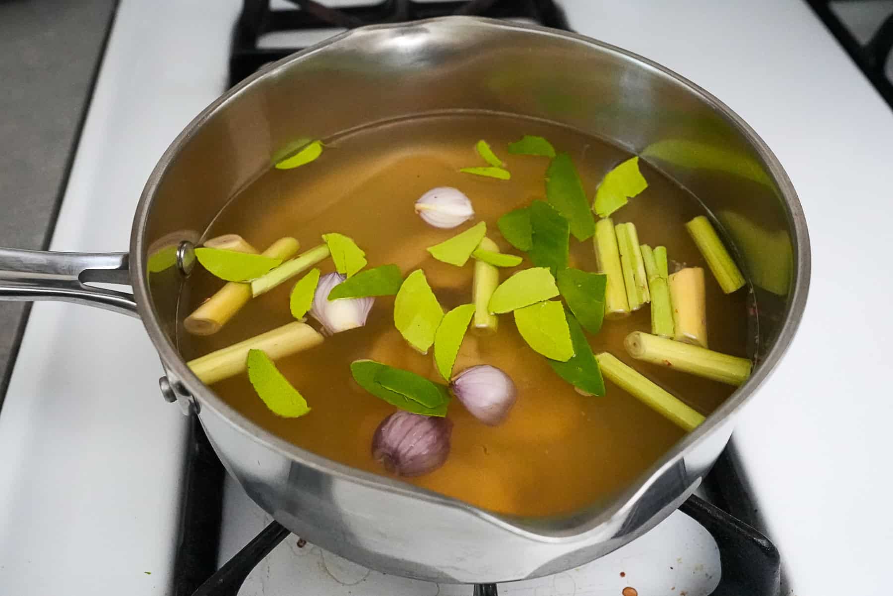 Add the herbs to the chicken broth and allow to simmer.