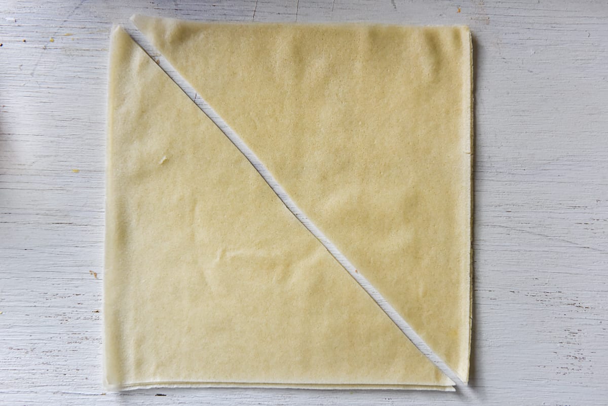Cut spring roll wrapper in half diagonally