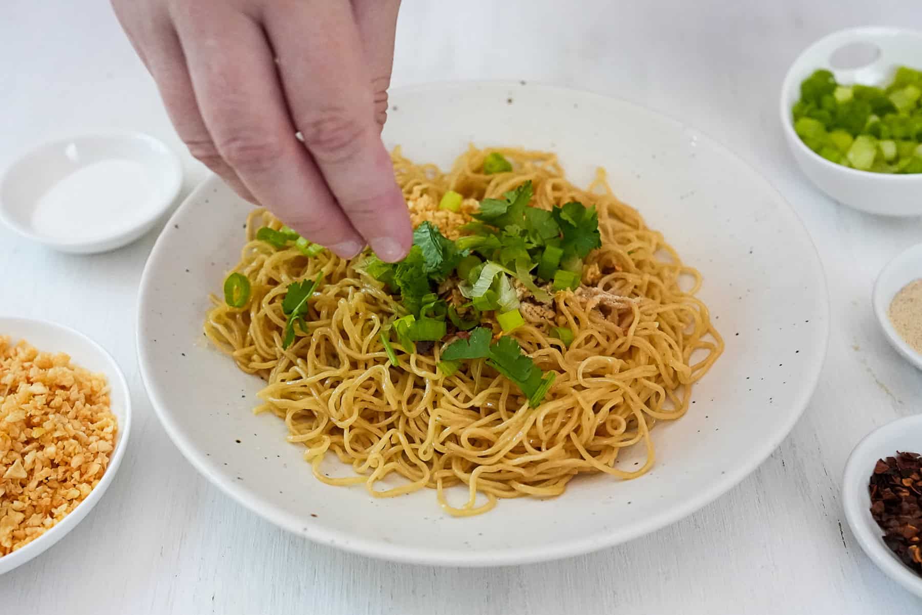 Sprinkle bamee hang with cilantro and green onions