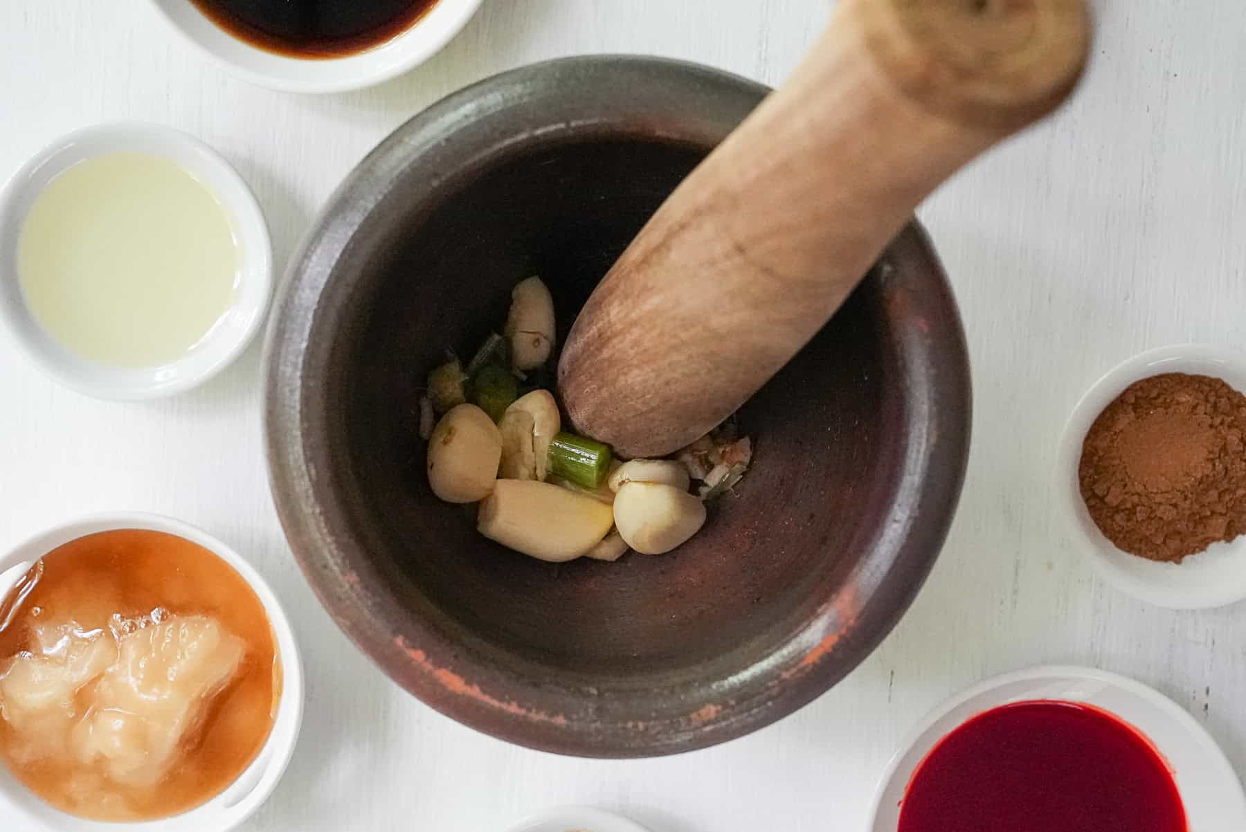 pound the garlic and cilantro roots into a paste